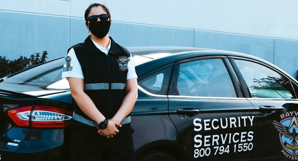 Professional woman in security uniform beside vehicle, illustrating a security guard career.