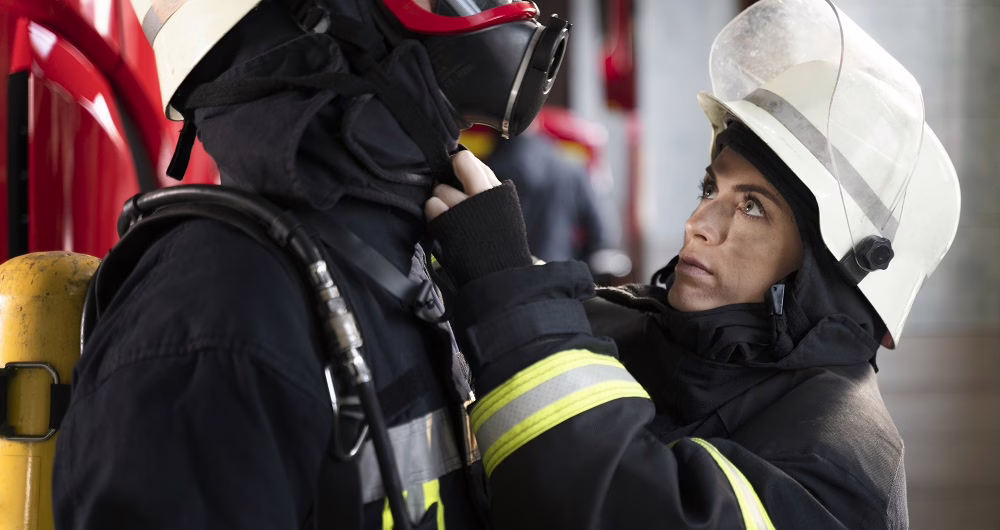 a fireman helping there colleague fire mask