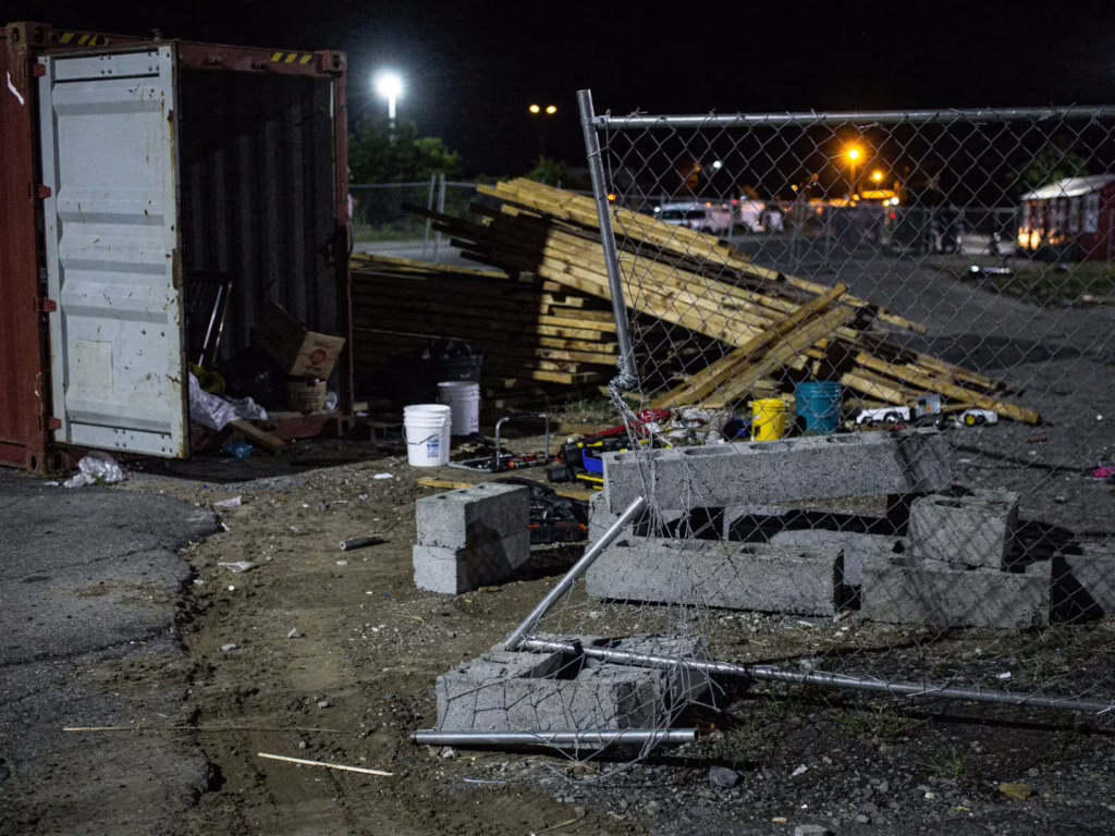 Damaged fencing and unsecured materials at a construction site at night, showing common construction site security risks in San Jose