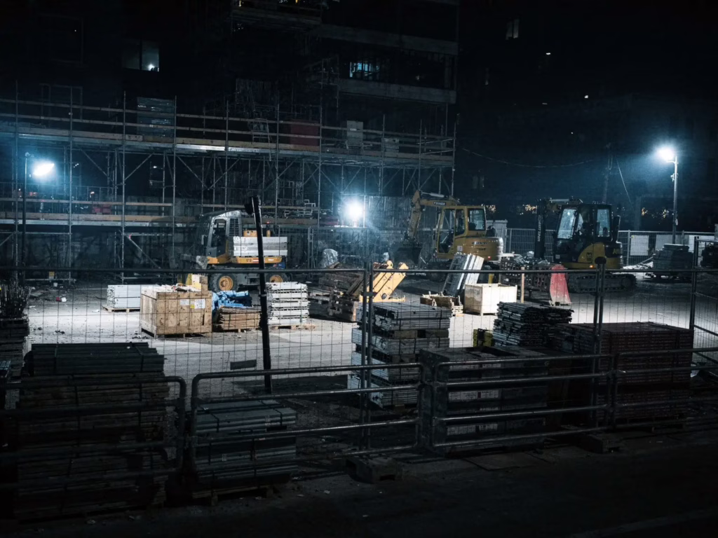 Unattended construction site at night with equipment and materials exposed, showing why construction site security in San Jose matters